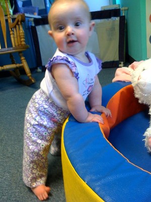 kivrin-pulling-up-on-dino-cushy