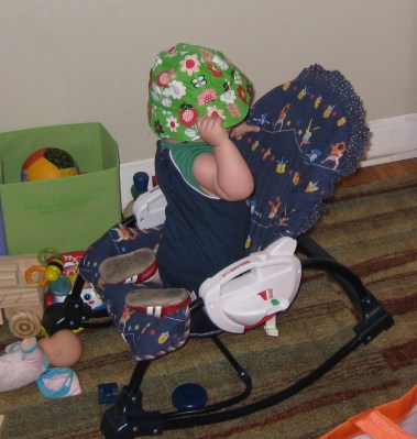 kivrin climbing in her chair and putting on her hat