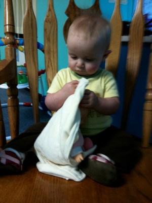 playing with her doll in the chair at school